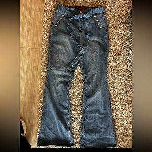 GuessFlared Denim Jeans with Button Detail.